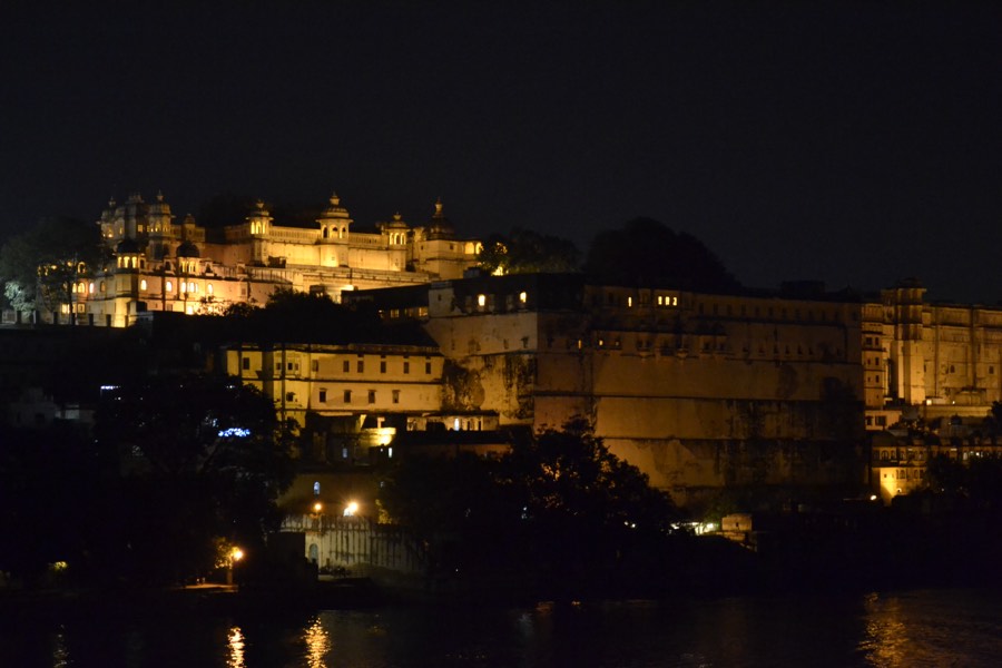 A hilltop fort lit up against the night sky