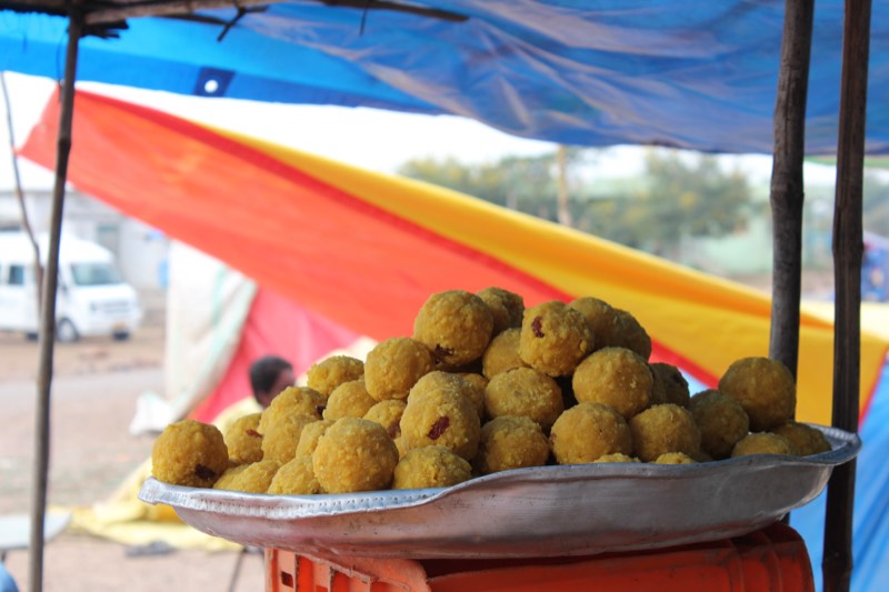 A plate of laddus at a roadside sweet stall