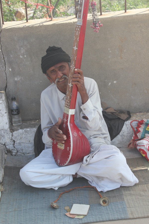A street musician playing a stringed instrument