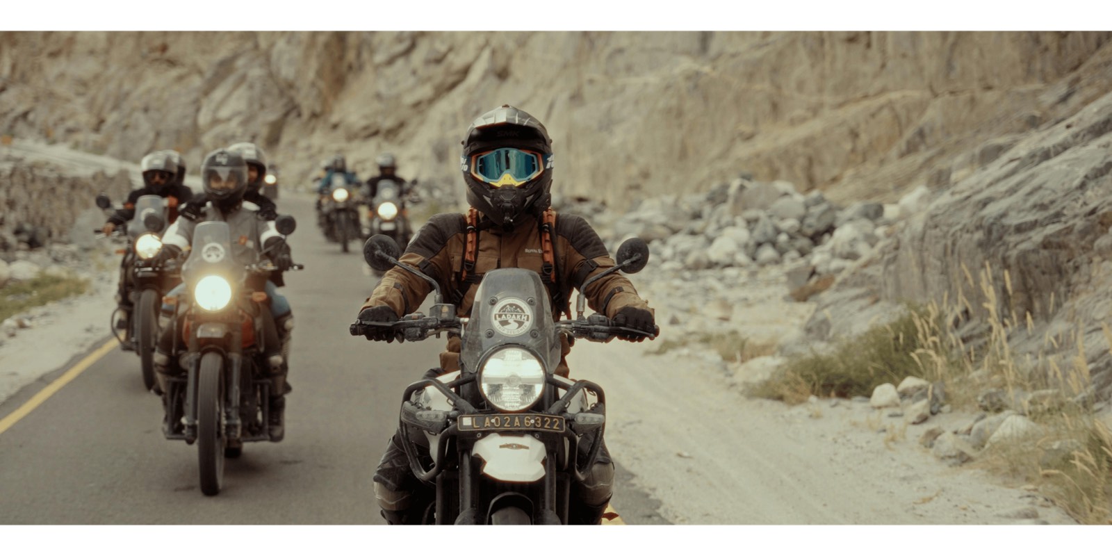 Motorcyclists riding a mountain road in convoy