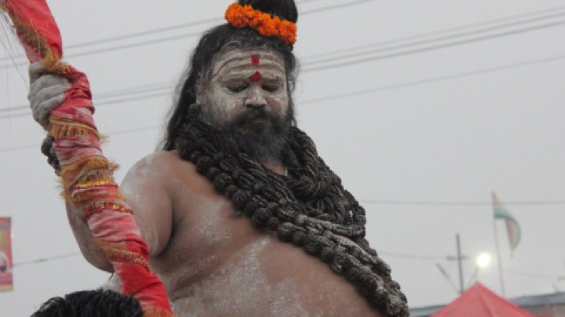 A sadhu with rudraksha garlands at a roadside gathering